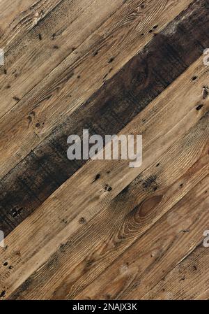 Diagonal rustic wooden wall made from old driftwood, background image in vertical format Stock Photo