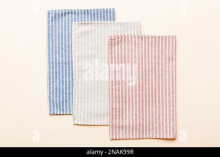 top view with gray kitchen napkin isolated on table background. Folded cloth for mockup with copy space, Flat lay. Minimal style. Stock Photo