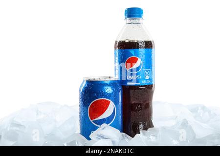 MYKOLAIV, UKRAINE - FEBRUARY 11, 2021: Plastic bottle and can of Pepsi on ice cubes against white background Stock Photo