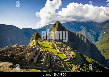 The ancient Incan city of Machu Picchu sits high in the Andes mountains of Peru. Stock Photo