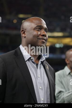 Football Hall of Fame member Eric Dickerson (R) jokes with fellow member  and former St. Louis Rams running back Marshall Faulk following a ceremony  honoring Faulk during halftime of the Cincinnati Bengals - St. Louis Rams  football game at the Edward