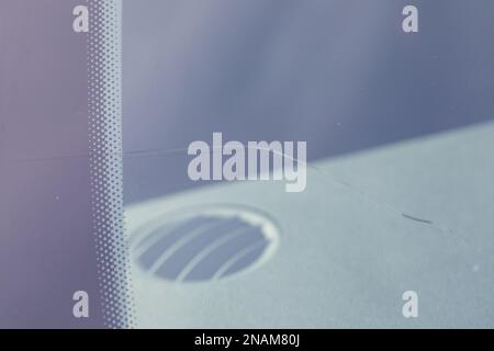 Cracked windshield in the car, close-up of scratches on the glass. Stock Photo