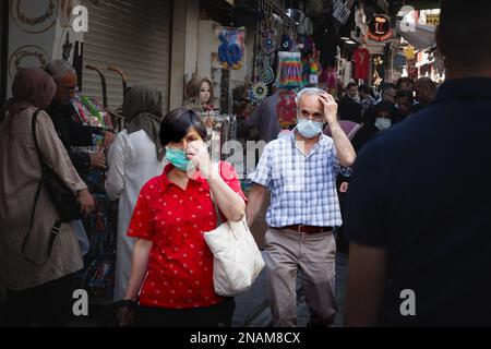 Picture of an senior old man and woman wearing a respiratory face mask in the kapalicarsi grand bazaar of Istanbul in Turkey during the Covid 19 pande Stock Photo