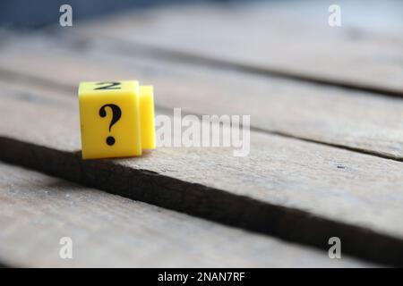 Question mark on a yellow cube. Place for text. Vintage style. Stock Photo
