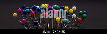 colorful pins on black background Stock Photo