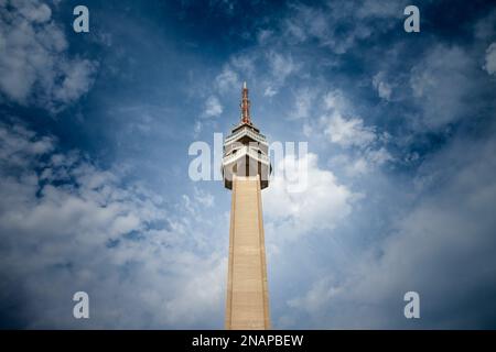 Picture of the Avala tower seen from the nearby forest. The Avala Tower is a 204.68 m tall telecommunications tower located on Mount Avala, in Belgrad Stock Photo