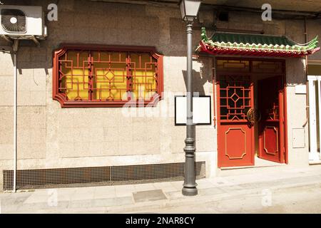 Entrance facade of a Chinese restaurant with a pagoda roof on a sunny day Stock Photo