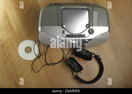 old radio tape recorder with record and headphones on the panel floor from above Stock Photo