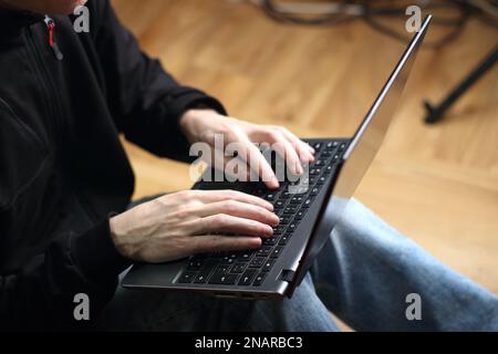 person is typing on a laptop keyboard Stock Photo