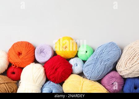 Different colorful woolen yarns on white background, flat lay. Space for text Stock Photo