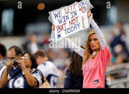 Vanessa Holmes of Beaumont Texas holds up a sign in the stands