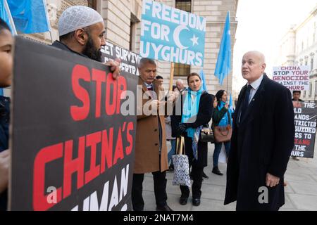Iain Duncan Smith (right) joins a vigil taking place outside the Foreign Office in London to protest at the planned visit to the UK of Erkin Tuniyaz, governor of the Chinese region at the centre of the persecution of the Uyghur minority. Picture date: Monday February 13, 2023. Stock Photo