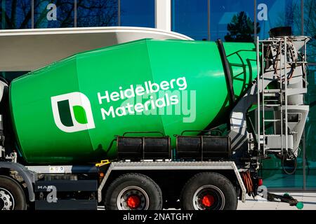 Heidelberg, Germany. 13th Feb, 2023. A company logo of the building materials group 'Heidelberg Materials', formerly 'HeidelbergCement', is attached to a concrete mixer parked in front of the company headquarters. Credit: Uwe Anspach/dpa/Alamy Live News Stock Photo