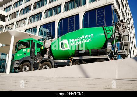 Heidelberg, Germany. 13th Feb, 2023. A company logo of the building materials group 'Heidelberg Materials', formerly 'HeidelbergCement', is attached to a concrete mixer parked in front of the company headquarters. Credit: Uwe Anspach/dpa/Alamy Live News Stock Photo