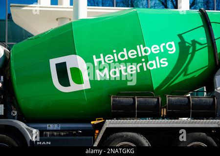 Heidelberg, Germany. 13th Feb, 2023. A company logo of the building materials group 'Heidelberg Materials', formerly 'HeidelbergCement', is attached to a concrete mixer parked in front of the company headquarters. Credit: Uwe Anspach/dpa/Alamy Live News Stock Photo