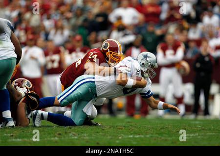 Washington Redskins defensive end Adam Carriker (94) talks with outside  linebacker Ryan Kerrigan (91) during the third quarter of an NFL football  game against the Miami Dolphins, Sunday, Nov. 13, 2011, in