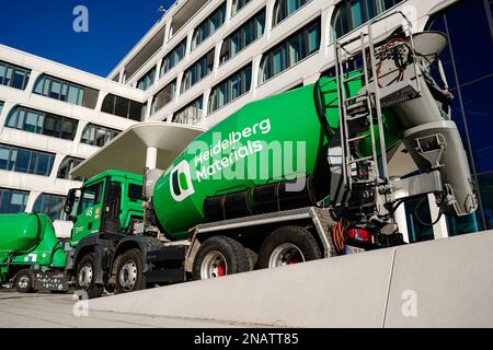 Heidelberg, Germany. 13th Feb, 2023. A company logo of the building materials group 'Heidelberg Materials', formerly 'HeidelbergCement', is attached to a concrete mixer parked in front of the company headquarters. Credit: Uwe Anspach/dpa/Alamy Live News Stock Photo