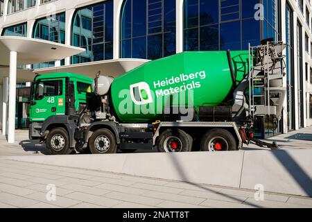 Heidelberg, Germany. 13th Feb, 2023. A company logo of the building materials group 'Heidelberg Materials', formerly 'HeidelbergCement', is attached to a concrete mixer parked in front of the company headquarters. Credit: Uwe Anspach/dpa/Alamy Live News Stock Photo