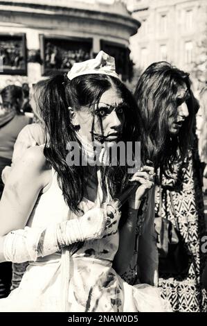 PARIS, FRANCE - OCTOBER 3, 2015: Zombie nurse holding a syringe filled with fake blood participating in Zombie parade at Place de la Republique. Zombi Stock Photo