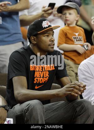 Texas basketball player Kevin Durant, left, walks with his mother, Wanda  Pratt, center and Texas coach Rick Barnes after announcing he will enter  the June NBA draft in Austin, Texas, Tuesday, April