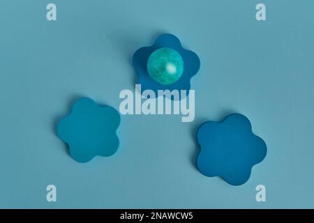 Painted aquamarine egg, wooden round podium. Flat lay Stock Photo