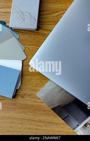 top view of sheet of paper, smartphone, notebook, colors samples, lagurus spikelets and laptop on beige background Stock Photo