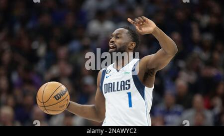 Dallas Mavericks guard Theo Pinson, right, reacts after scoring and drawing  a foul alongside forward Nic Claxton (33) in the second half of an NBA  basketball game against the Dallas Mavericks, Wednesday