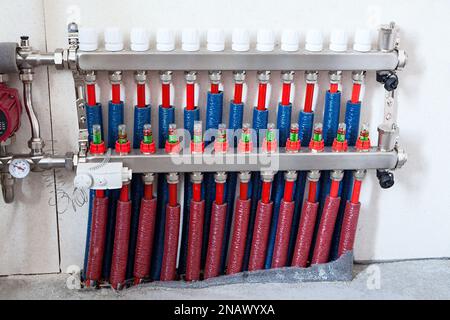 Distribution manifold for underfloor heating, direct and return lines Stock Photo