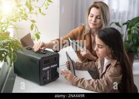 The inverter generator charges the power bank battery Stock Photo