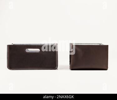 Storage baskets of brown faux leather for organizing office space Stock Photo