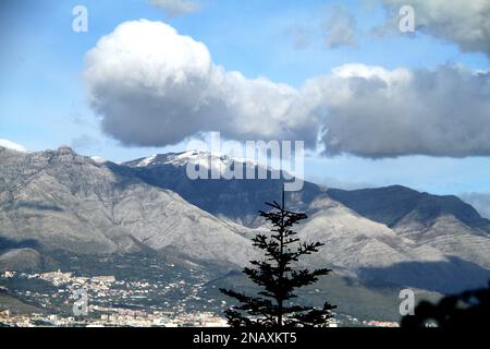 The Aurunci Mountains in December, viewed from Gaeta, Italy. Odd-shaped cloud. Stock Photo