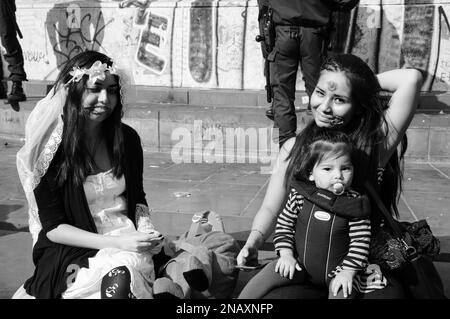 PARIS, FRANCE - OCTOBER 3, 2015: Young zombie womans with baby during Zombie parade at Place de la Republique. Zombie Walk is an annual event in Paris Stock Photo