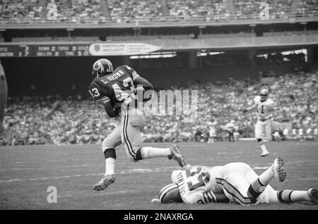 Larry Brown (43), premier runner in the Washington redskins backfield,  usually draws a crowd of opponents when he carries the ball-as in this  scene in the redskins-Green Bay Packers playoff game, Dec.