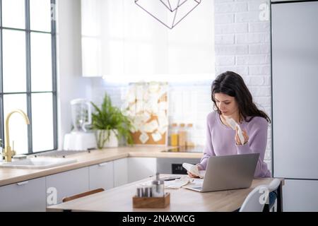 economical woman work on phone calculator at home pay bills taxes on gadget online, provident female calculate finances expenditures, manage plan Stock Photo