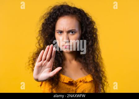 Uninterested woman disapproving with NO hand sign gesture. Denying, rejecting Stock Photo