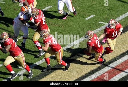 San Francisco 49ers linebacker Segun Olubi (49) and Minnesota Vikings guard Austin  Schlottmann (65) pose for