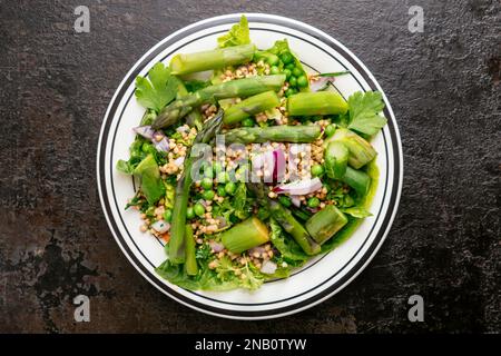 Spring Salad with Asparagus and Peas, served with buckwheat. Stock Photo