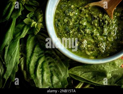 Photo of delicious traditional italian pesto sauce. Horizontal photo, Close-Up shot. Green color palette. Stock Photo
