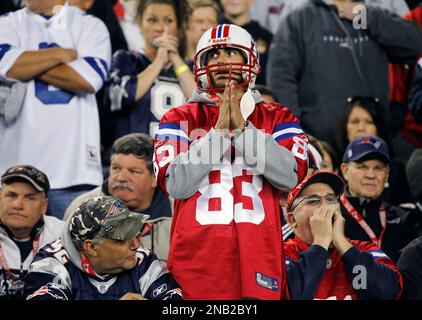 New England Patriots fan Joey Romano, of Scarborough, Maine, climbs the  steps outside Gillette Stadium with his father Paul, wearing the #12 jersey,  prior to an NFL football game, Sunday, Jan. 2