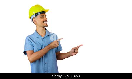Black Man in Safety Helmet and Blue Shirt isolated on orange. Stock Photo