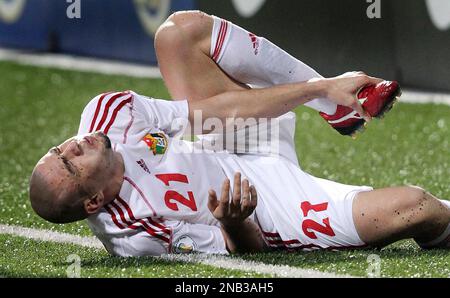 Odai Al Saify of Jordan reacts after being tackled during their FIFA