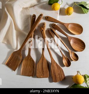 wooden kitchen tools with lemons on white marble Stock Photo