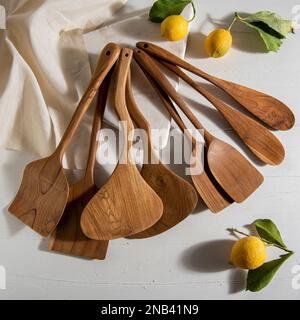 wooden kitchen tools with lemons on white marble Stock Photo