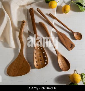 wooden kitchen tools with lemons on white marble Stock Photo