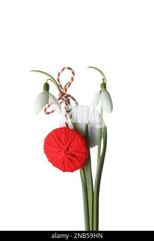 Beautiful snowdrops with traditional martisor on white background. Symbol of first spring day Stock Photo