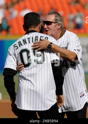 Former Florida Marlins Charlie Hough, left, and Benito Santiago, of Puerto  Rico, congratulate each other after Hough threw a ceremonial first pitch to  Santiago before the start of a baseball game between