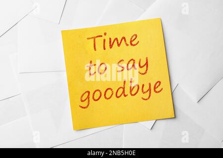 Note with phrase Time to say goodbye on paper sheets, top view Stock Photo