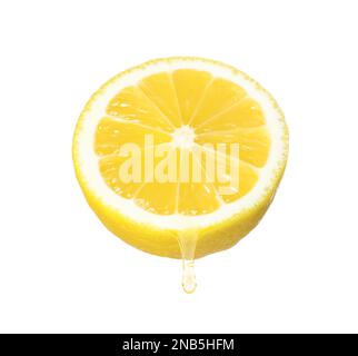 Lemon juice dripping from fruit on white background Stock Photo