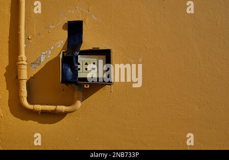 The old rusty electrical switch on a wall Stock Photo