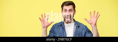 Scared man with raised his hands up and shouting sees something in front Stock Photo